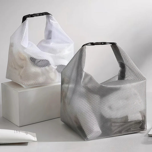 Two mesh shopping bags on a light gray background