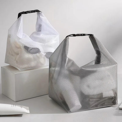 Two mesh shopping bags on a light gray background